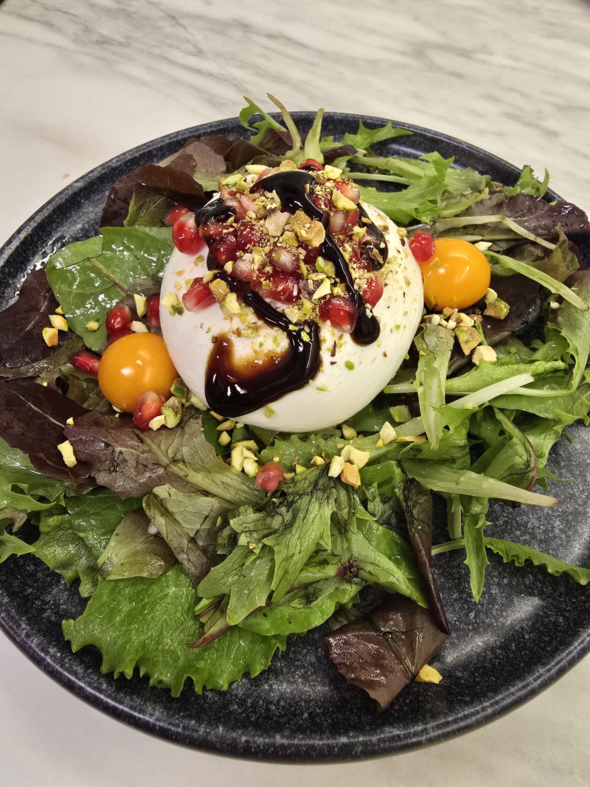 Burrata cheese salad with pomegranate