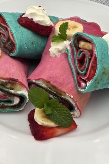 Rainbow crepe rolls with whipped cream