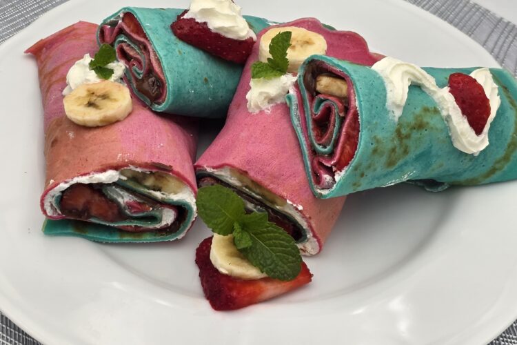 Rainbow crepe rolls with whipped cream